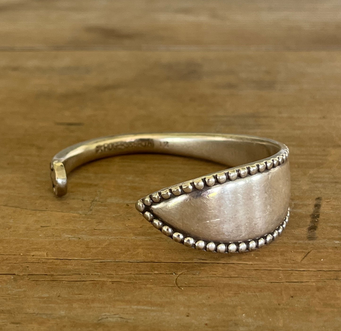 Close-up of Vesta Rogers Bros. silver-plate spoon cuff bracelet showing beaded border detail - handcrafted from upcycled vintage silverware - Laughing Frog Studio