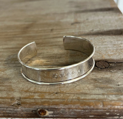 Close-up of Barbara script monogram on vintage Gorham sterling silver napkin ring cuff bracelet
