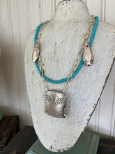 Hand beaded turquoise colored beads paired with vintage silverware and antique belt buckle
