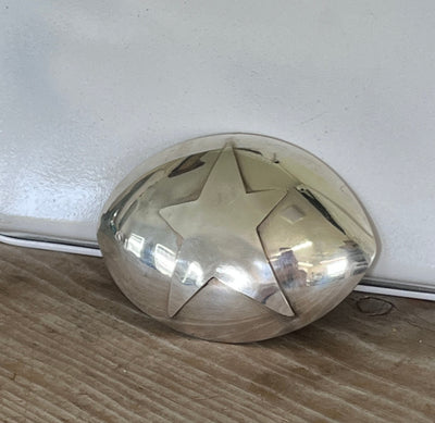 Close-up of stylized star belt buckle showing detailed star pattern on reclaimed vintage spoon, handmade western accessory