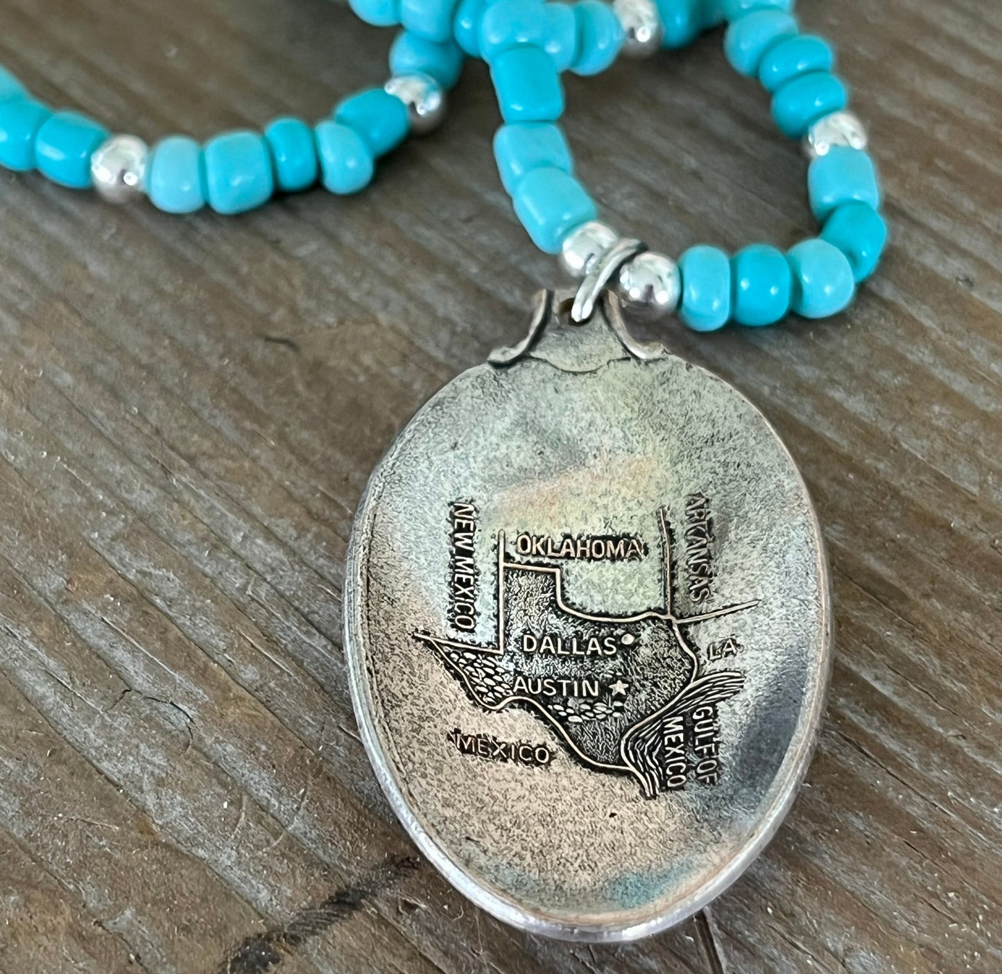 Detail view of Texas Pride pendant necklace featuring Arthur A. Everts Jewelry Co. Texas map on vintage silverware - silverware pendant necklace - handcrafted from upcycled vintage silverware - Laughing Frog Studio