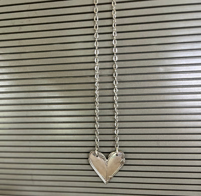Shot of a hanging MEADOWBROOK pattern fork handle heart necklace - Fork Handle Heart Necklace - handcrafted from upcycled vintage silverware - Laughing Frog Studio