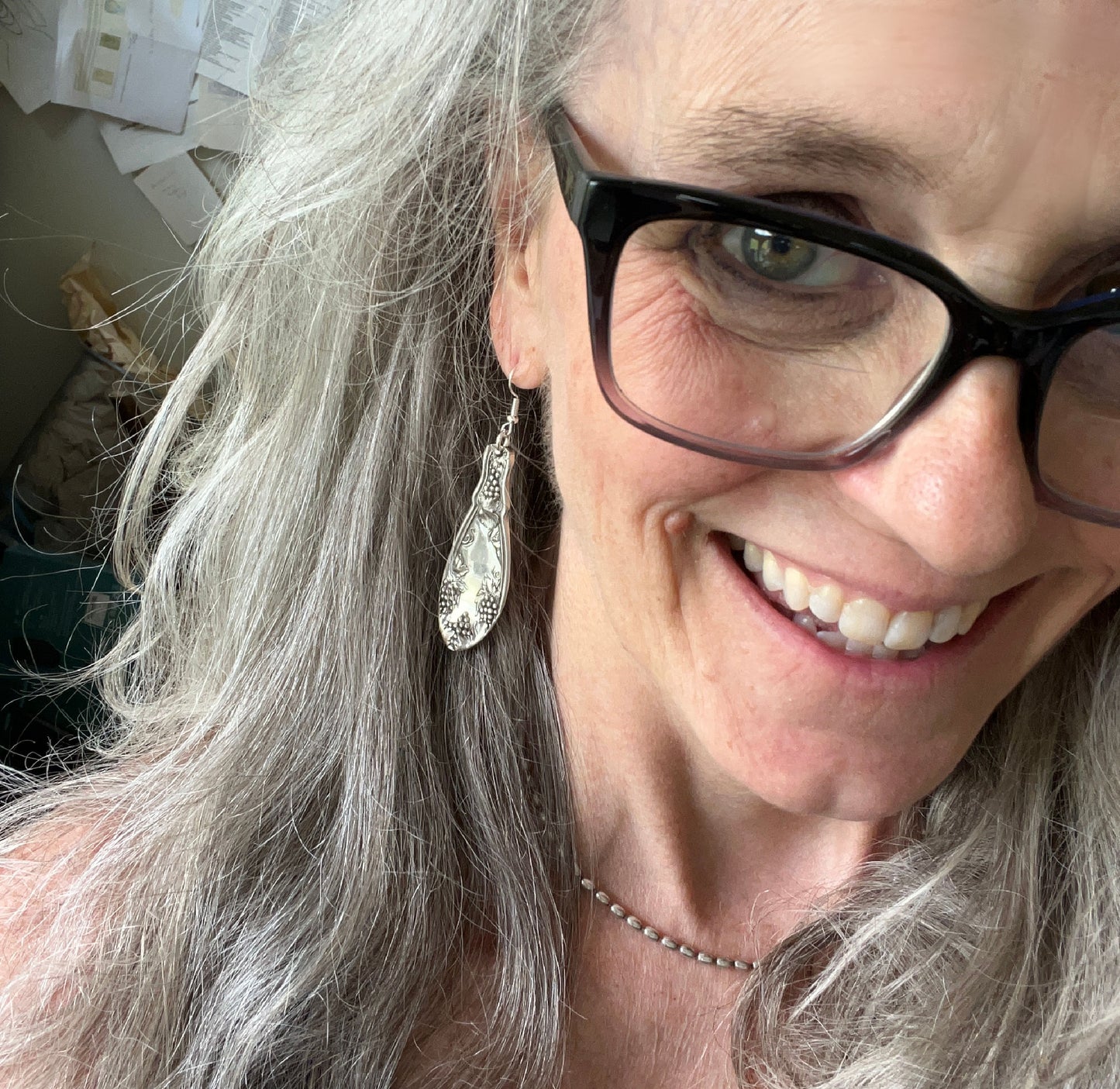 La Concorde spoon earrings modeled on ear showing wearable fit and elegant vintage silverware design