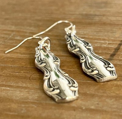 Close-up detail of elegant Interlude pattern spoon handle earrings, upcycled vintage silverware, 2.375 inches long