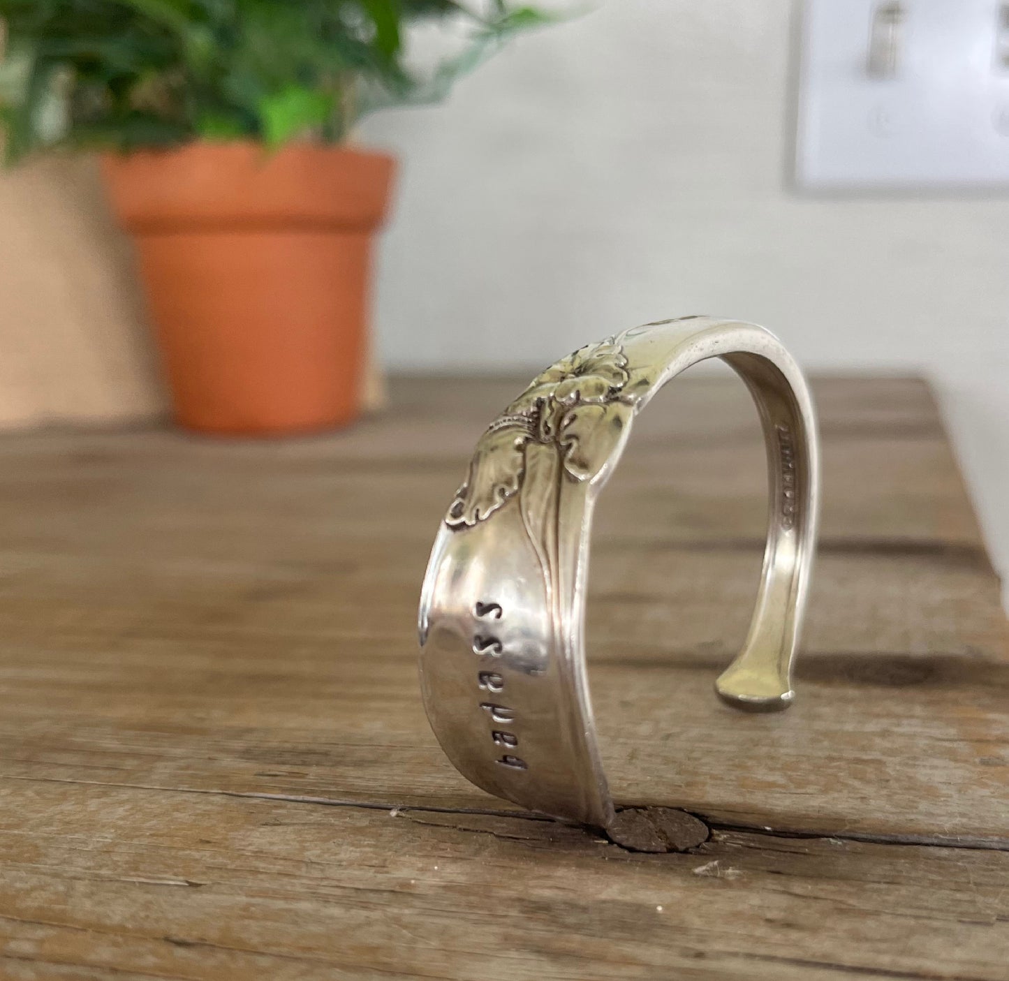 Standing view of BADASS hand-stamped vintage Community White Orchid silverplate spoon cuff bracelet - hand-stamped spoon cuff bracelet - handcrafted from upcycled vintage silverware - Laughing Frog Studio