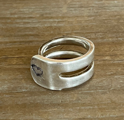Side view of BEATING HEART double fork tine ring showing silverware construction and heart design