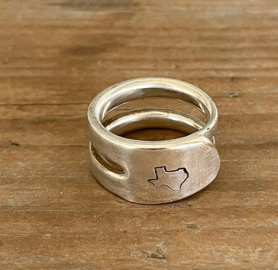 Group of hand-stamped double fork tine rings in various designs including Texas, daisies, and hearts - handcrafted from upcycled vintage silverware - Laughing Frog Studio