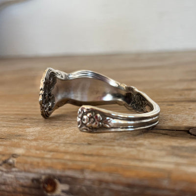 Close-up detail of Arbutus pattern spoon cuff bracelet showing organic flowing lines and vintage silverplate
