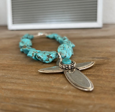 Close-up of cross pendant made from four vintage Argosy spoon handles - upcycled silverplate statement piece