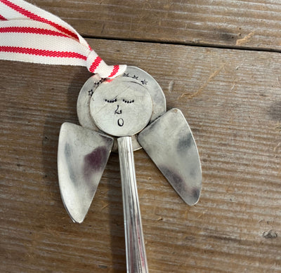 Close-up detail of hand-stamped face of Josephine pattern artisan angel ornament with spoon handle body and spoon bowl wings - handcrafted upcycled vintage silverware ornament - Laughing Frog Studio