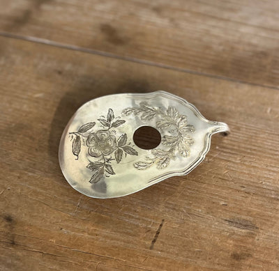 Flat lay of Fair Oak guitar spoon belt buckle - upcycled vintage Wm. Rogers & Son silverplate accessory for music lovers - Laughing Frog Studio