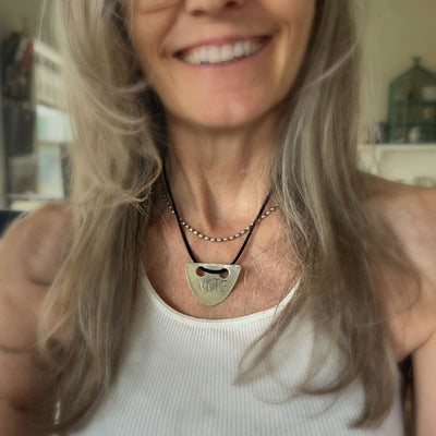 VOTE hand-stamped vintage spoon necklace worn on model showing pendant length and choker fit with black faux suede cord - upcycled silverware spoon necklace - handcrafted from upcycled vintage silverware - Laughing Frog Studio