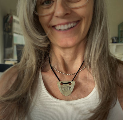 VOTE hand-stamped vintage spoon necklace worn on model showing pendant length and choker fit with black faux suede cord - upcycled silverware spoon necklace - handcrafted from upcycled vintage silverware - Laughing Frog Studio