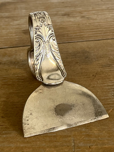 Ergonomic heart handle spoon cheese knife in Avalon pattern - front view showing full floral scrollwork handle detail - handcrafted from upcycled vintage silverware - Laughing Frog Studio