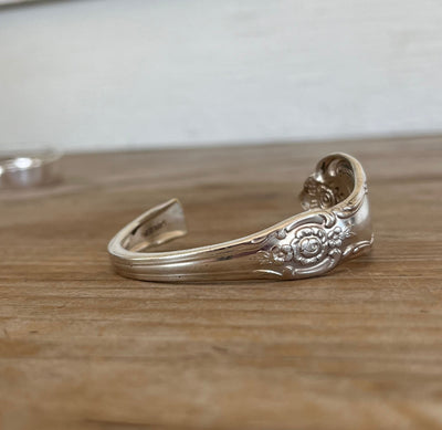 Close-up detail of Vanessa pattern spoon cuff bracelet showing fluid Art Nouveau curves and vintage silverplate