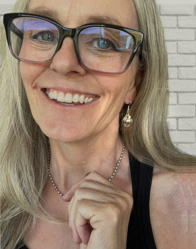 Cowgirl hat earrings modeled on ear showing wearable fit and playful Western style made from Roosevelt dimes