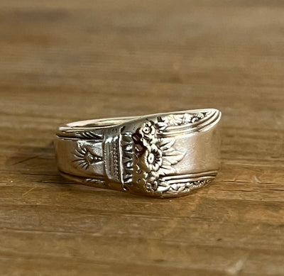 Detailed view of 1847 Rogers FIRST LOVE pattern spoon ring showing vintage silverware detail and craftsmanship - Laughing Frog Studio