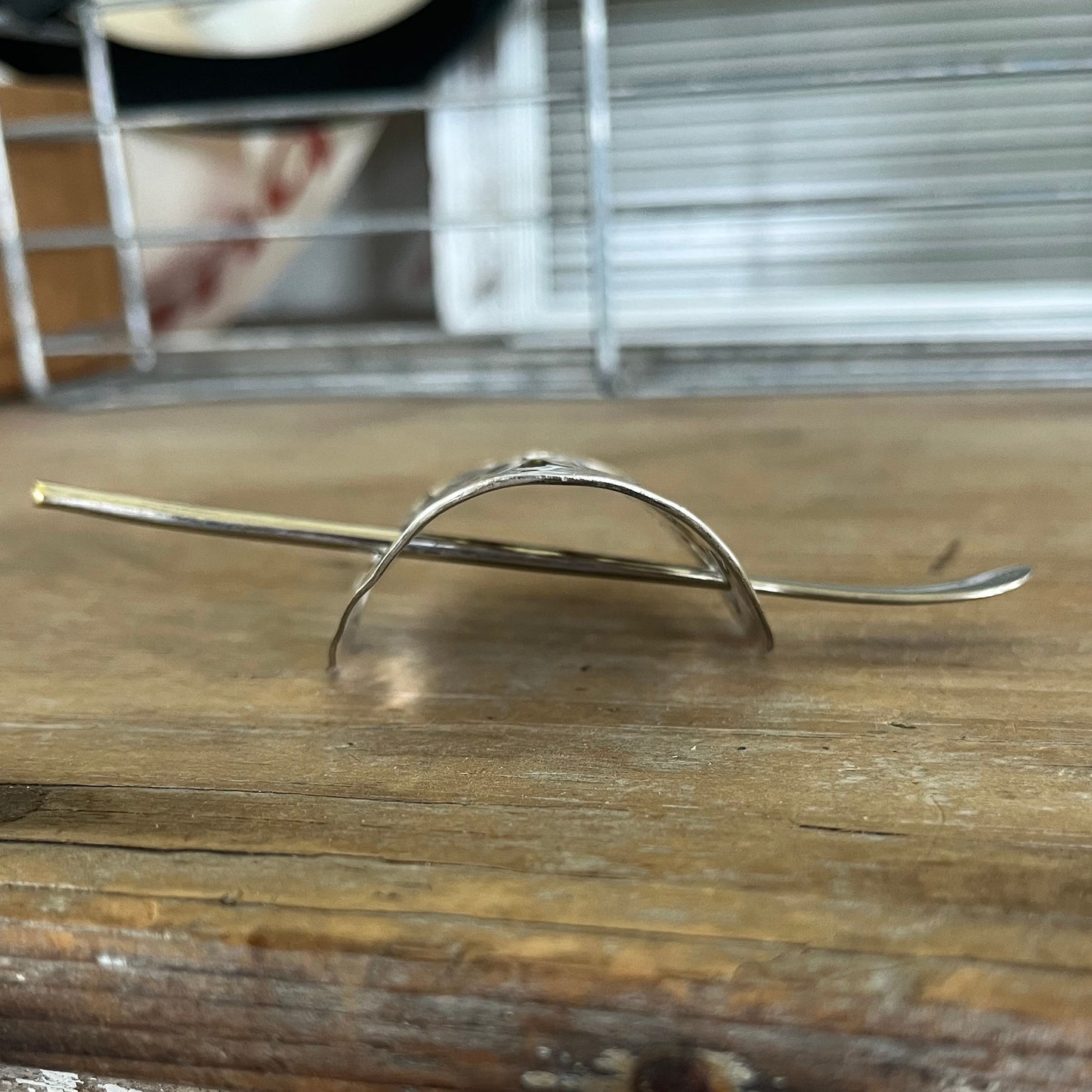 Side view of crescent-shaped cake server ponytail barrette showing curve and texture - upcycled vintage silverware - Laughing Frog Studio