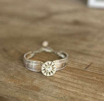 Close-up of sparkling rhinestone button centerpiece on Regent pattern spoon link bracelet - handmade artisan silverware jewelry