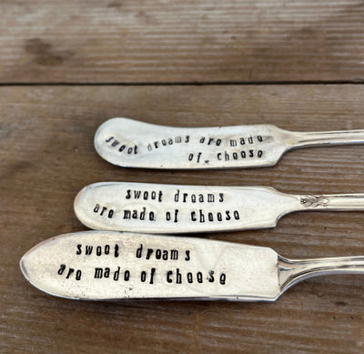 Close up of stamping on three Sweet Dreams Are Made of Cheese hand-stamped vintage cheese spreader - upcycled silverware cheese knife gift - handcrafted from upcycled vintage silverware - Laughing Frog Studio