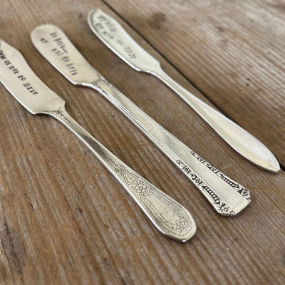 Close up of handles on three "To Brie or Not to Brie" hand-stamped cheese spreaders - hand-stamped cheese spreader - handcrafted from upcycled vintage silverware - Laughing Frog Studio