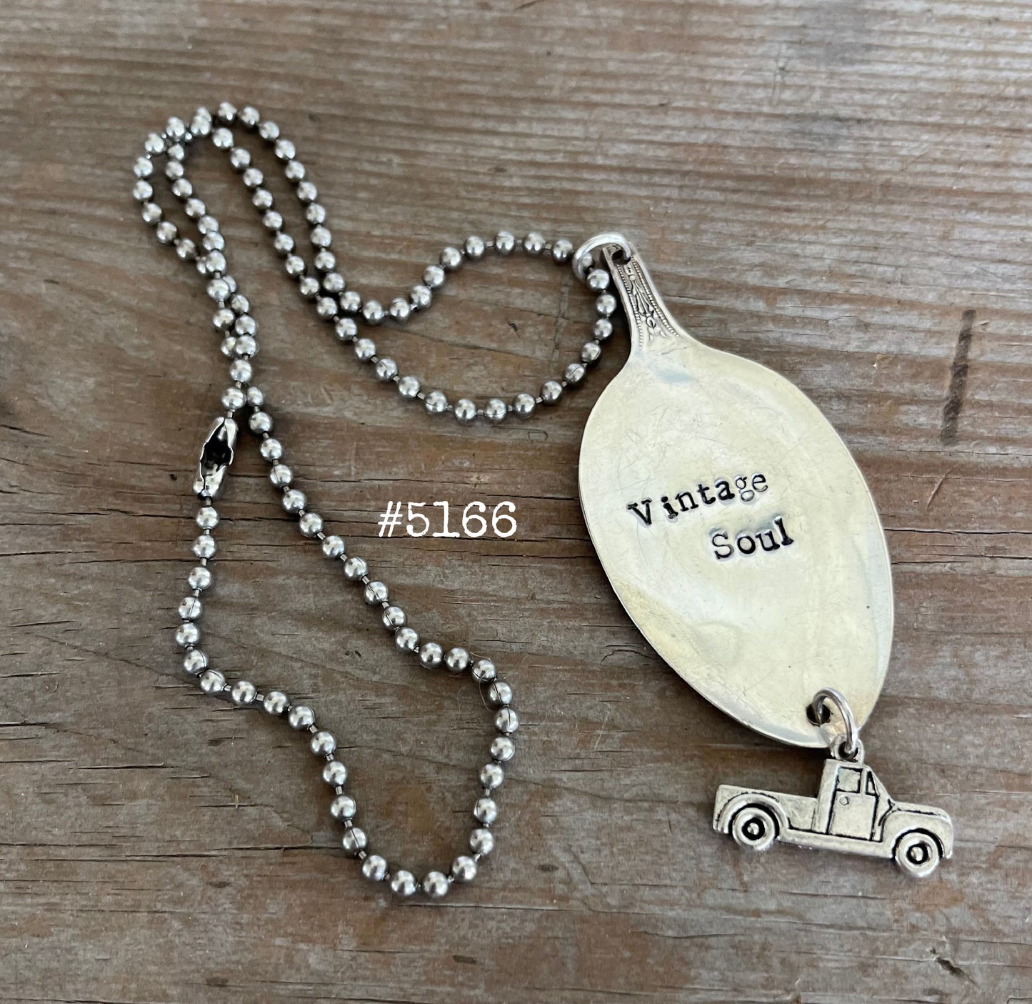 Detail of VINTAGE SOUL stamped spoon pendant showing hand-stamped lettering and vintage truck charm on upcycled silverware