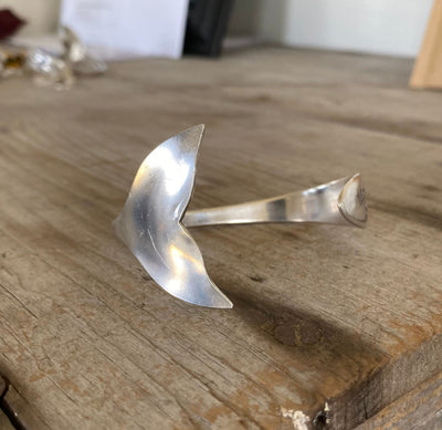 Close-up of sculpted Mermaid tail fin on vintage Lady Hamilton spoon cuff