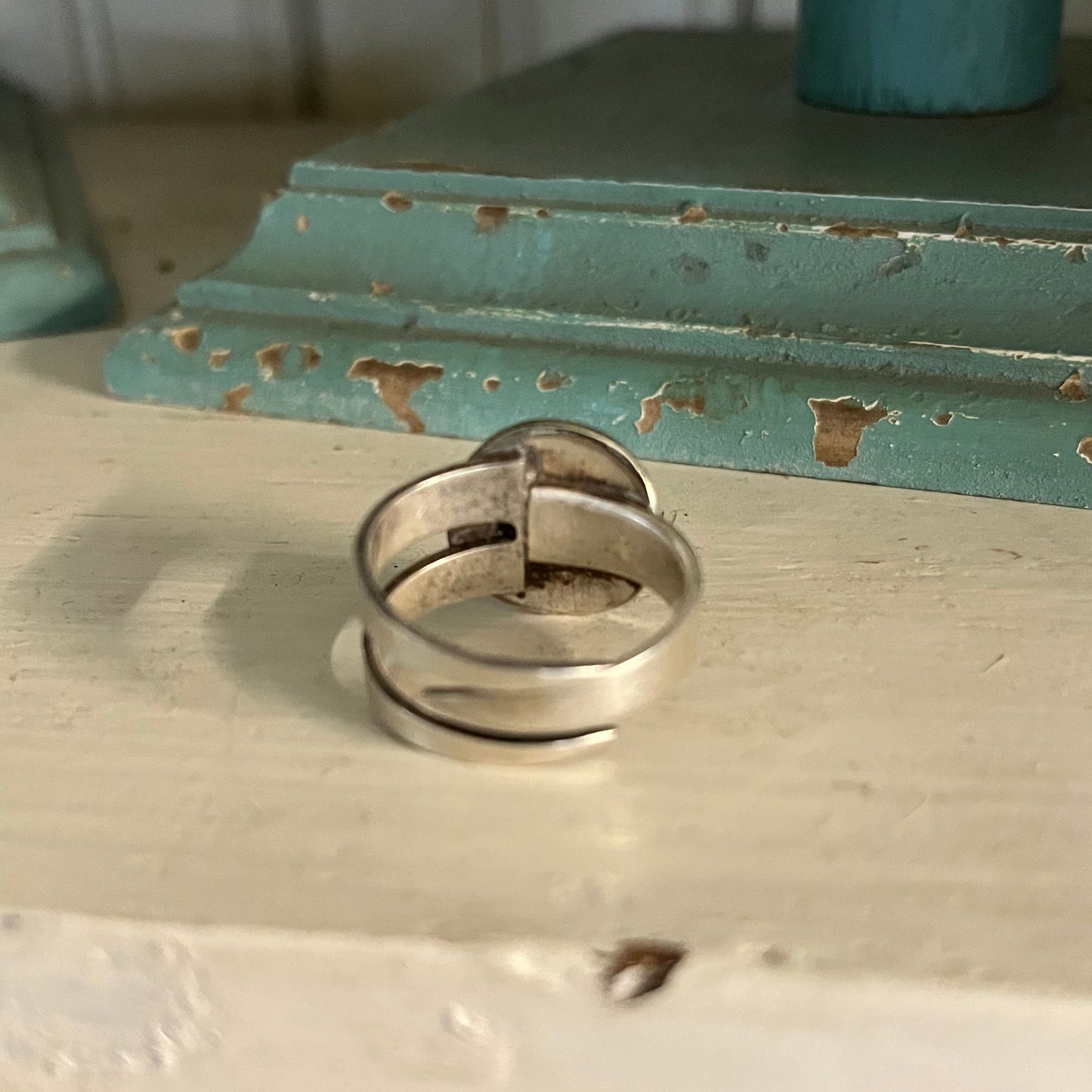 Detail of fork tine band construction on modern dot statement ring with spoon bowl accents