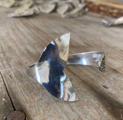 Upcycled silverware mermaid cuff highlighting the hand-carved tail fin and English Garden pattern detail