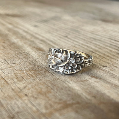 Close-up of ornate floral detailing on Kirk & Son Repoussé sterling silver spoon ring