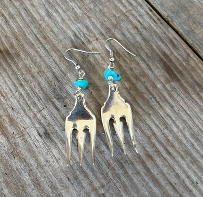 Close-up detail of cocktail fork tine earrings with turquoise stones showing scalloped edge and trident prongs, 2.625 inches long