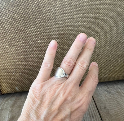 Mignonette sterling silver spoon ring shown on hand - handcrafted upcycled silverware jewelry