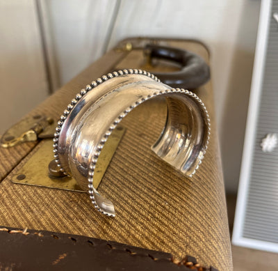 Side View of mid-20th century sterling silver cuff bracelet showing dotted edge pattern and vintage patina