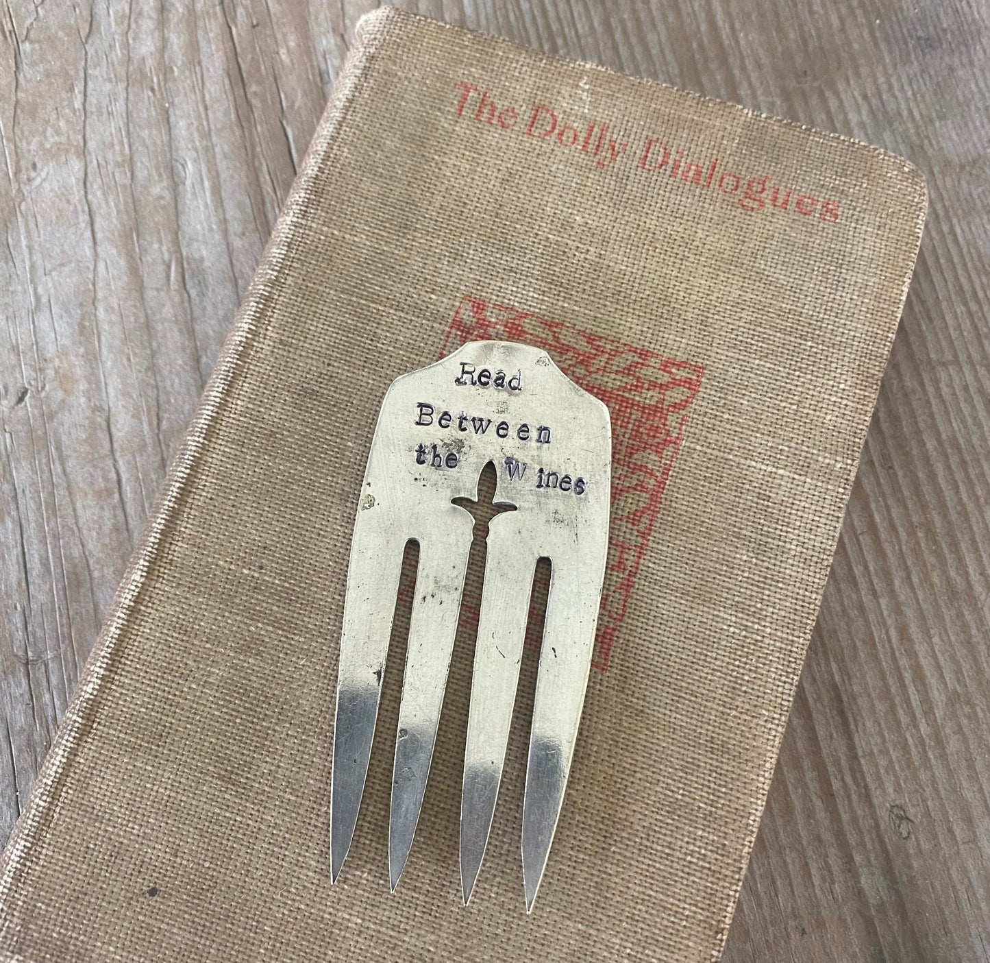 Handcrafted silverplate fork bookmark stamped READ BETWEEN THE WINES - unique literary pun gift