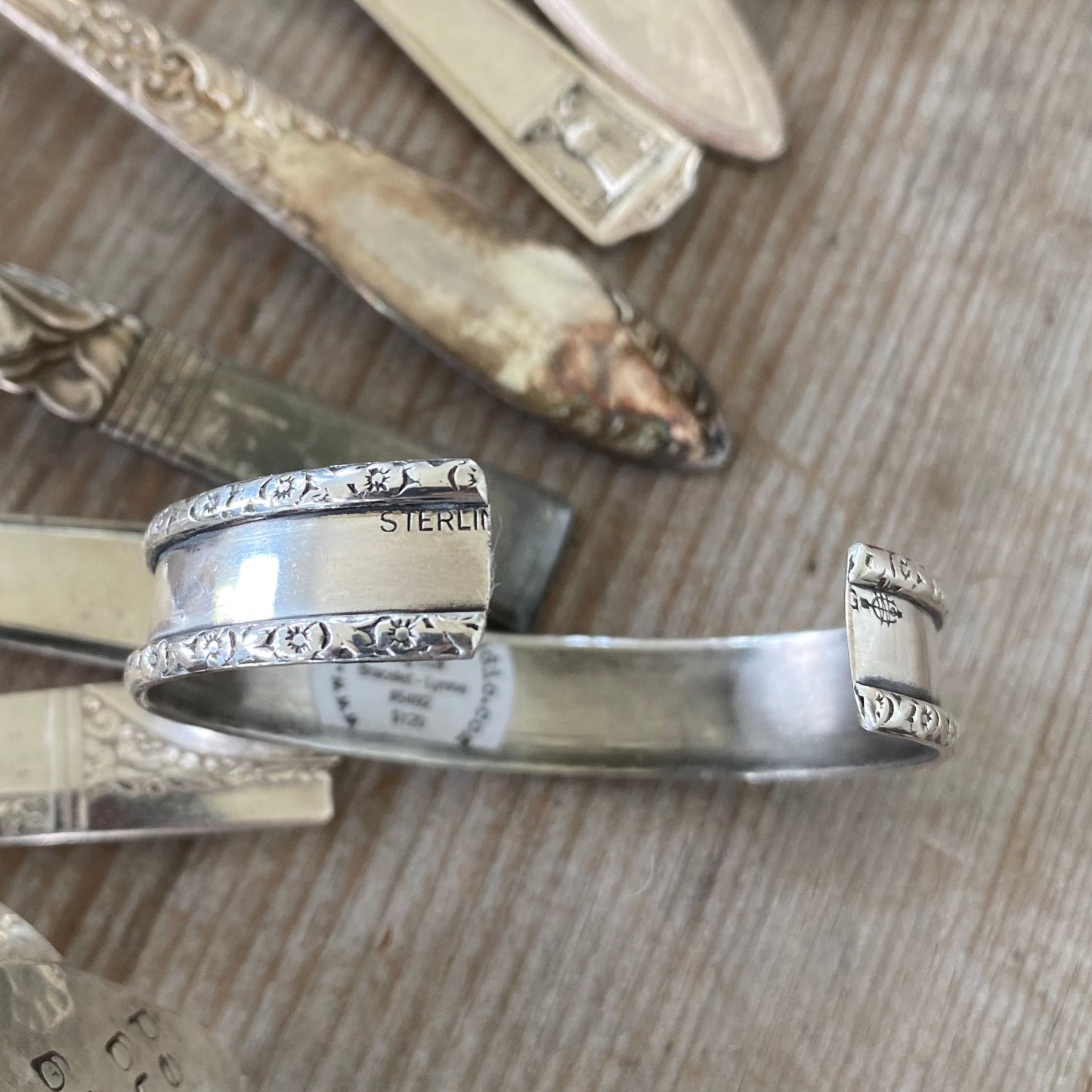 Close-up of Lynne sterling silver napkin ring cuff showing ornate vintage pattern detail as well as Webster marking