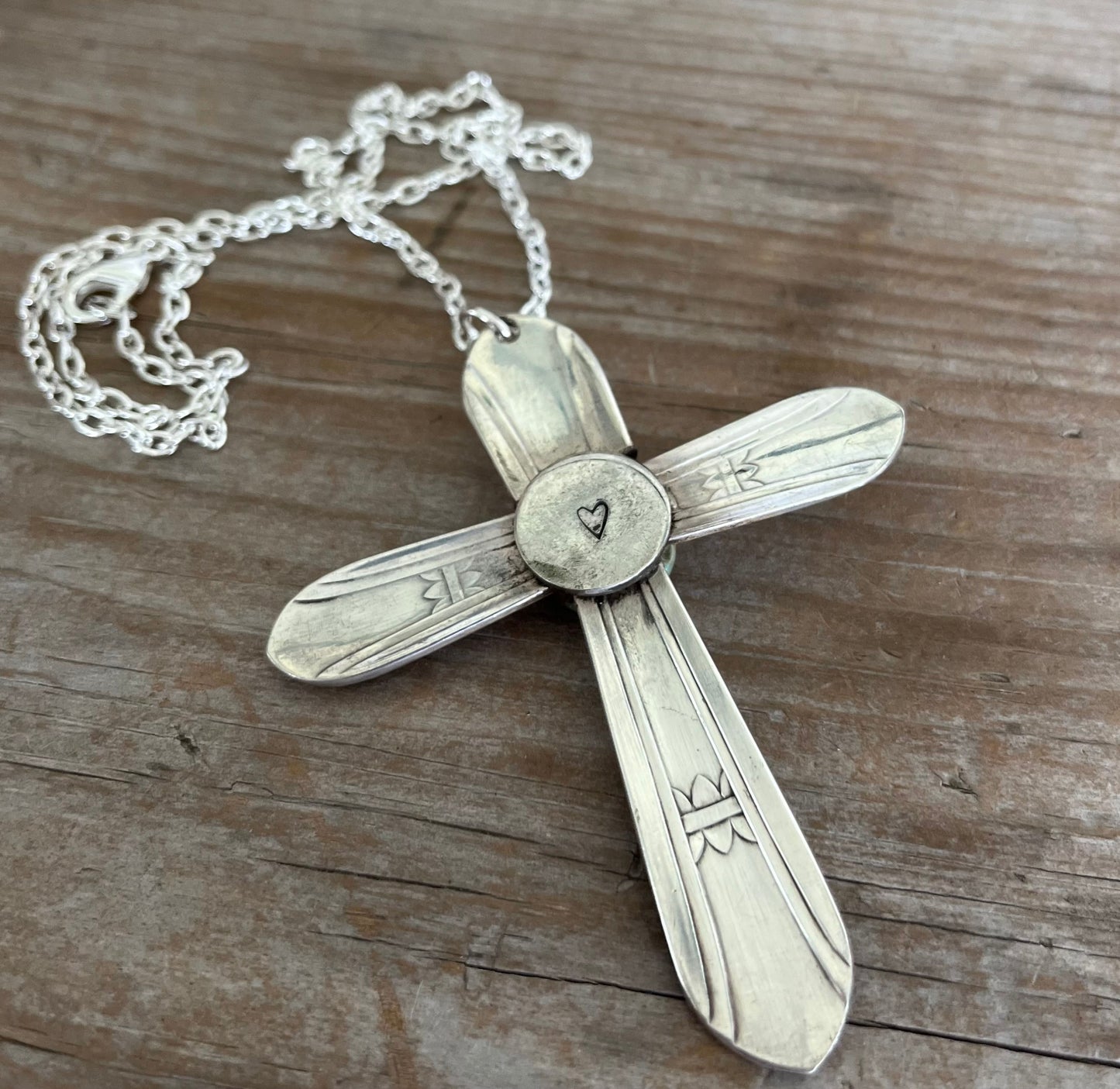 Back of Regent spoon cross showing heart-stamped circular detail - handcrafted upcycled vintage silverware