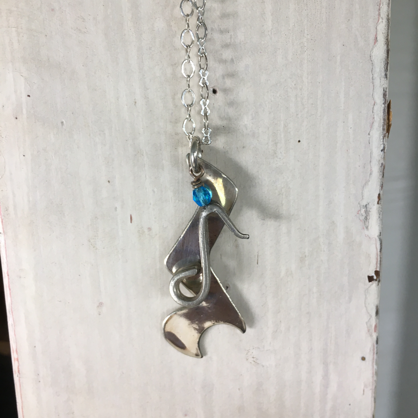 Spoon Artisan Necklace in the shape of a Quarter Rest and Eighth Note Musical Symbols Shown Hanging
