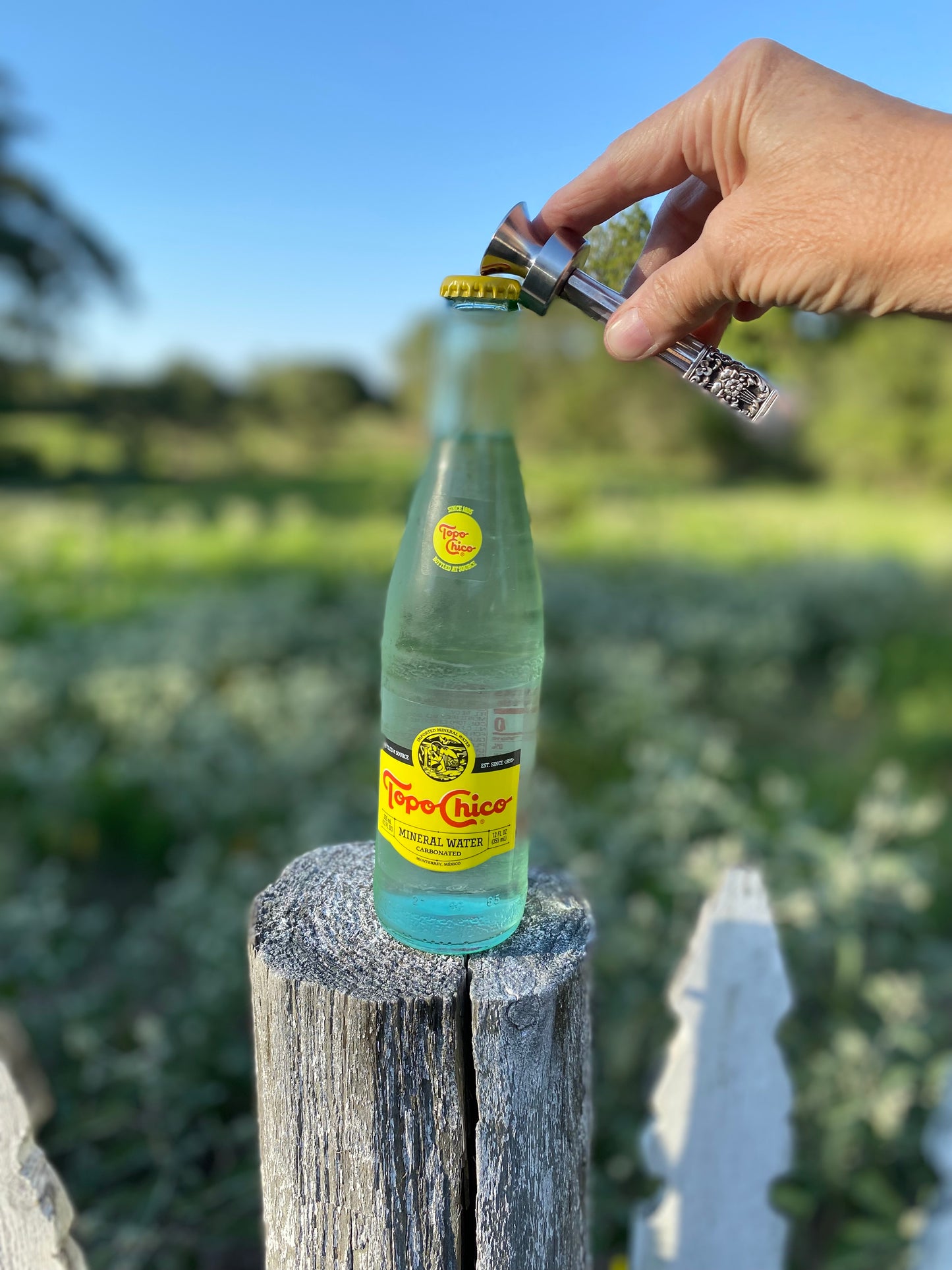 Handmade coronation knife handle bottle opener in use - upcycled vintage silverware bar cart accessory