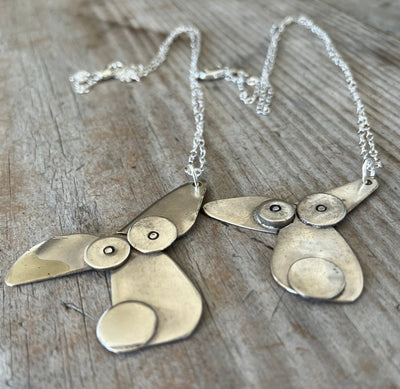 Close-up of dog lover necklace made from vintage silverplate spoon bowls