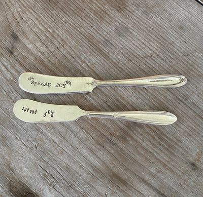 antique silverware spreaders stamped with Spread Joy message for charcuterie boards and cheese lovers