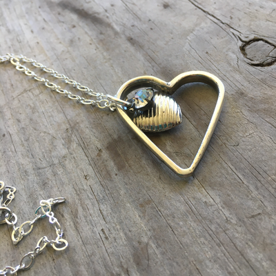 Close-up of floating heart pendant made from upcycled fork tines showing detail