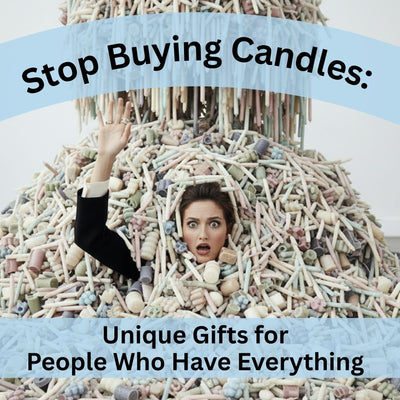 Woman buried in pile of pastel candles looking overwhelmed - stop buying candles - unique gifts from Laughing Frog Studio