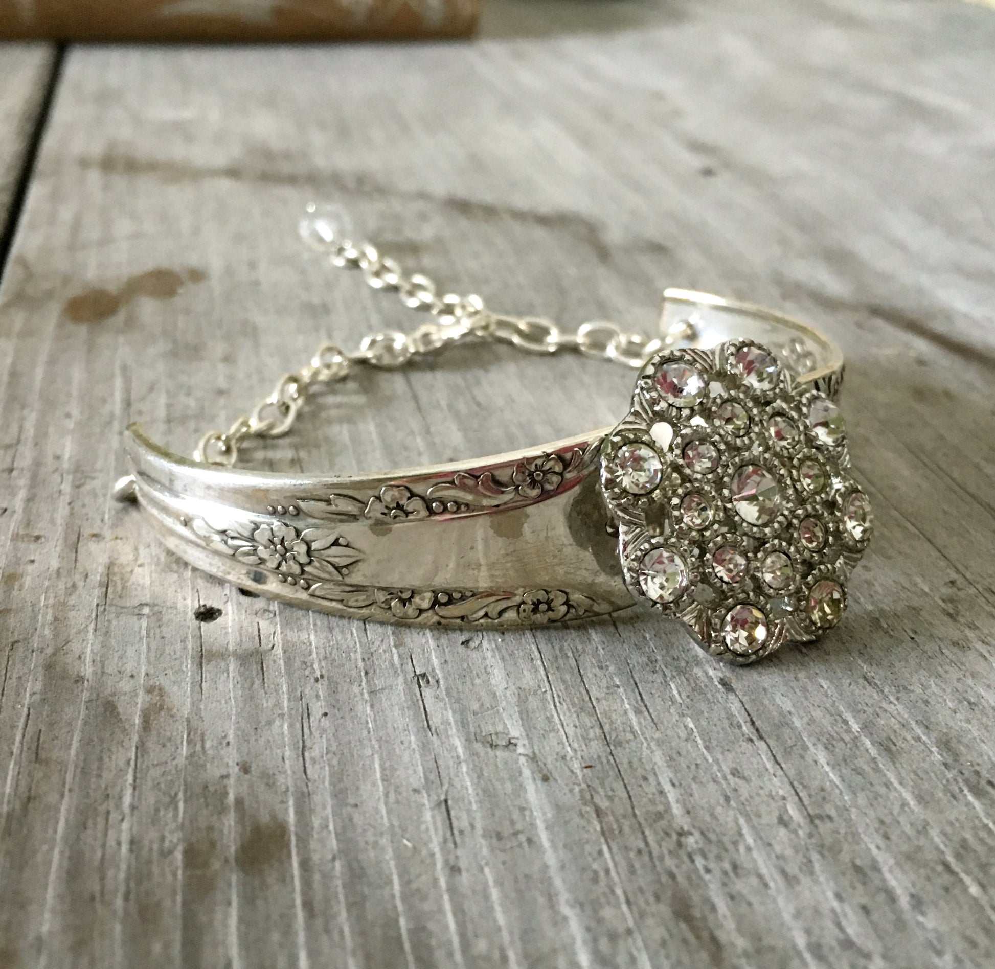 Detailed view of spoon cuff bracelet with rhinestone button center - spoon bracelet - handcrafted from upcycled vintage silverware - Laughing Frog Studio