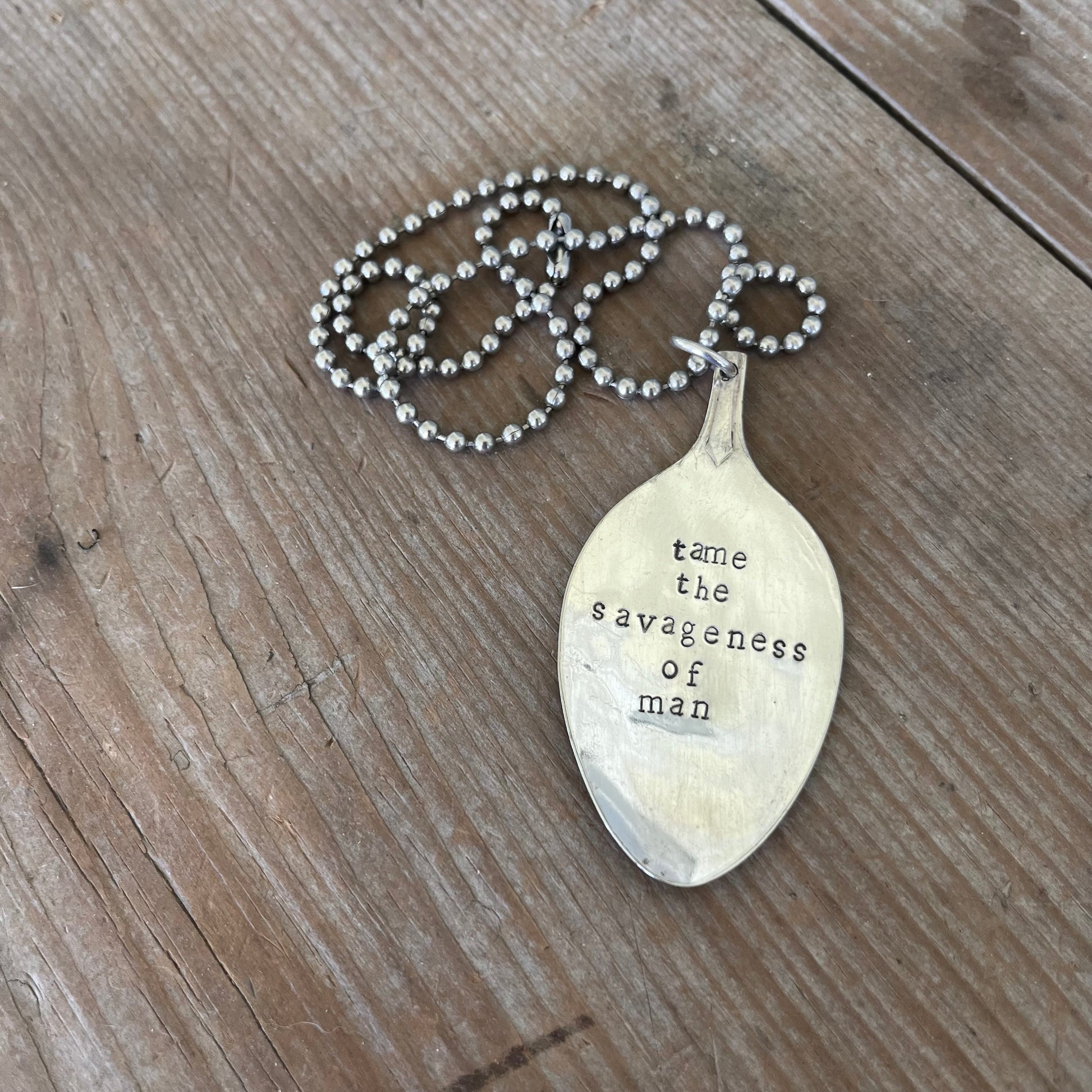 Handcrafted stamped spoon necklace with Robert Kennedy quote 'Tame the Savageness of Man' on upcycled vintage silverplate, meaningful jewelry