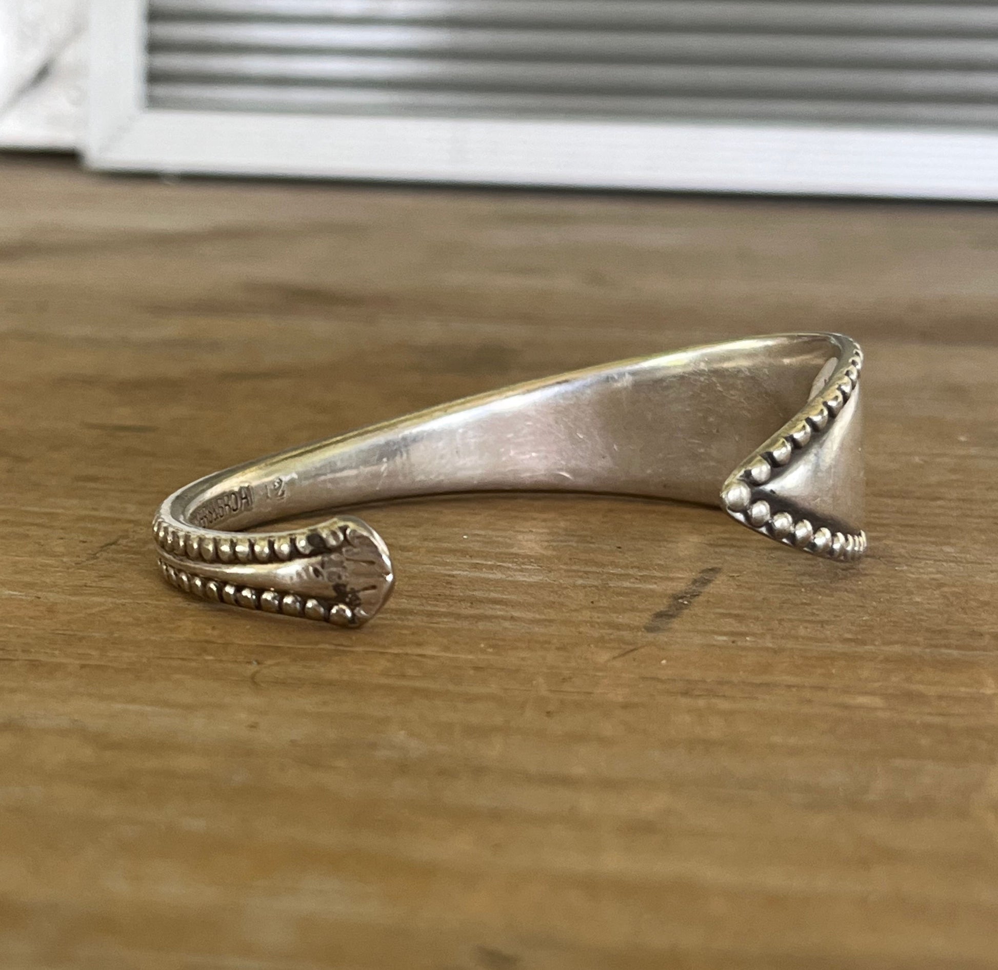 Vesta pattern Rogers Bros. spoon cuff bracelet flat lay showing full piece - handcrafted from upcycled vintage silverware - Laughing Frog Studio