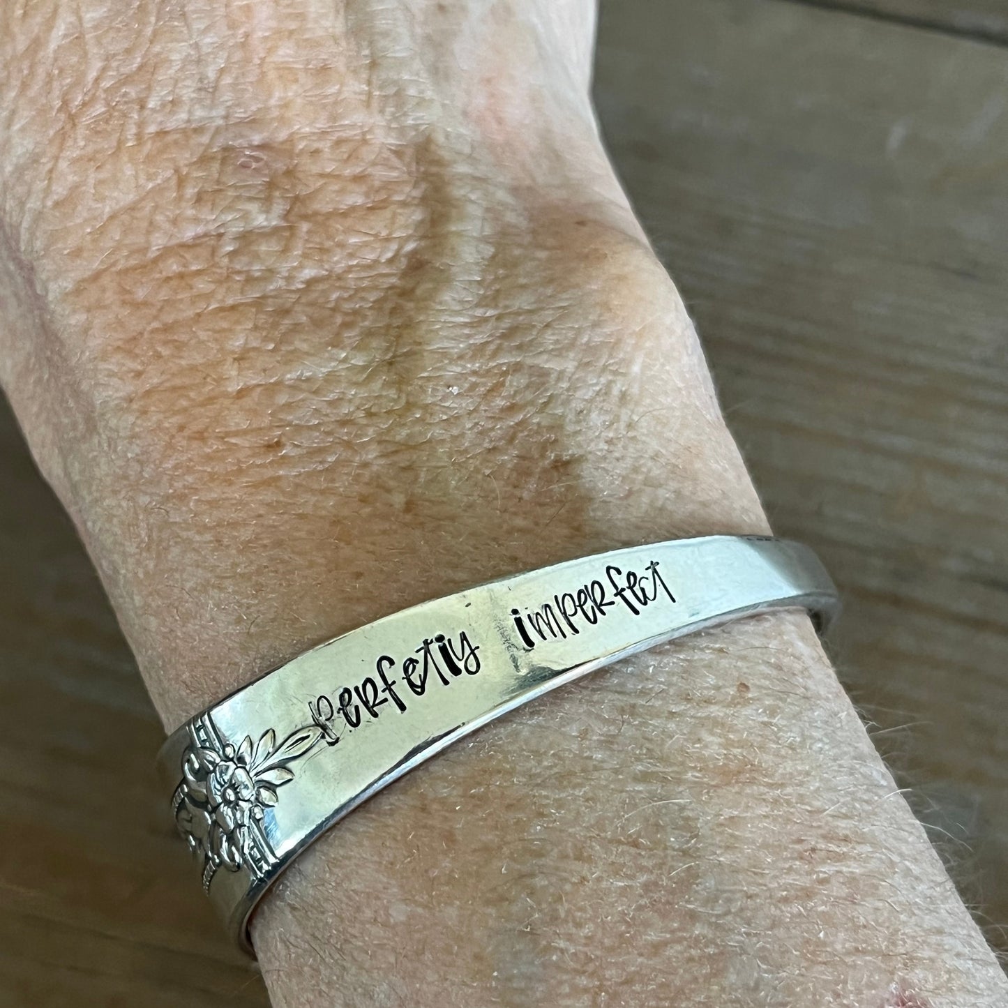 Perfectly imperfect hand-stamped spoon cuff bracelet worn on wrist - upcycled vintage silverware bracelet - handcrafted from upcycled vintage silverware - Laughing Frog Studio