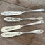 Collection of vintage cheese spreaders with Spread Love stamping - one-of-a-kind upcycled silverware gift