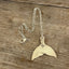 handmade spoon necklace shaped like a mermaid or whale tail