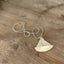 Close-up of vintage spoon sailboat pendant showing hand-stamped detail and anchor charm, sustainable artisan nautical jewelry