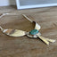 Close-up of Native Wings spoon pendant with stone bead - eco-friendly upcycled jewelry